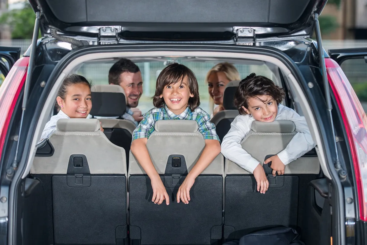Family loading a car after picking it up