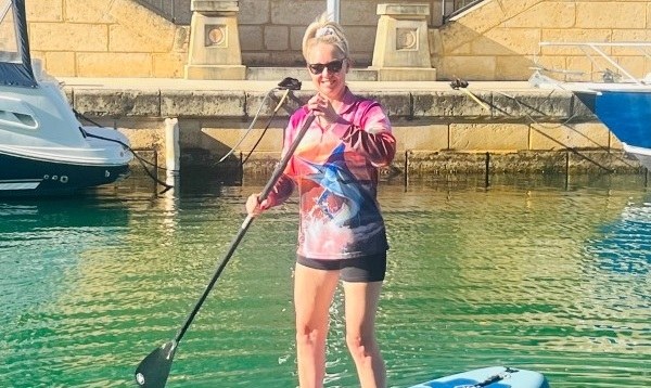 Liz out on a paddleboard on a calm Western Australian morning.