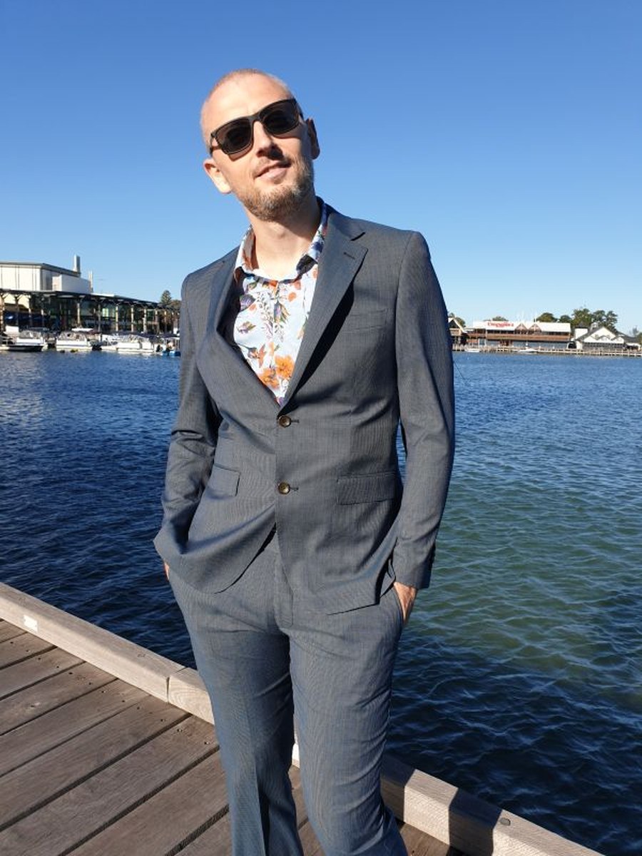 Daniel Reid, founder of Emanate Finance, standing on a jetty in Perth.